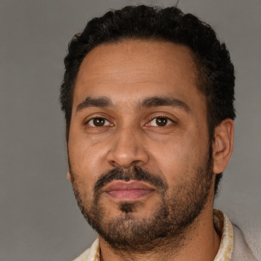 Neutral latino adult male with short  black hair and brown eyes