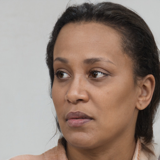 Neutral latino adult female with long  brown hair and brown eyes