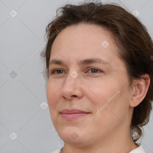 Joyful white adult female with medium  brown hair and brown eyes