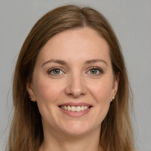 Joyful white young-adult female with long  brown hair and green eyes