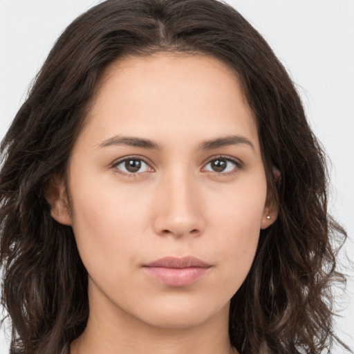 Neutral white young-adult female with long  brown hair and brown eyes