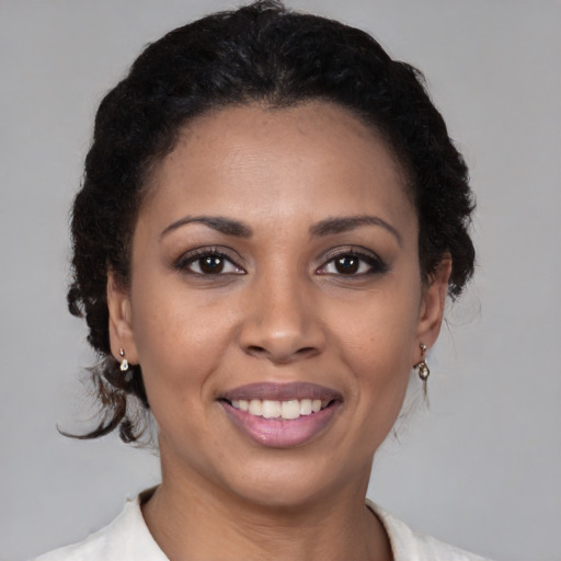 Joyful latino young-adult female with medium  brown hair and brown eyes