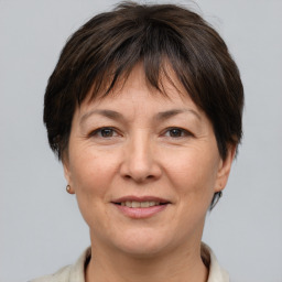 Joyful white adult female with short  brown hair and brown eyes