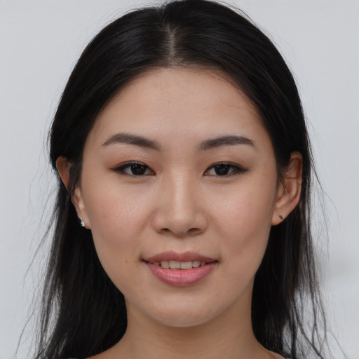 Joyful asian young-adult female with long  brown hair and brown eyes
