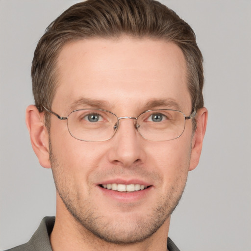 Joyful white adult male with short  brown hair and grey eyes