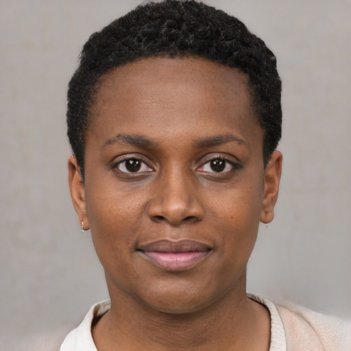 Joyful black young-adult female with short  black hair and brown eyes