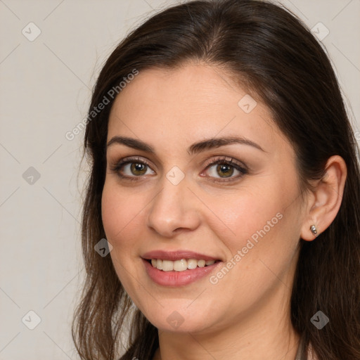 Joyful white young-adult female with long  brown hair and brown eyes