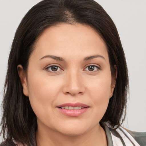 Joyful white young-adult female with medium  brown hair and brown eyes