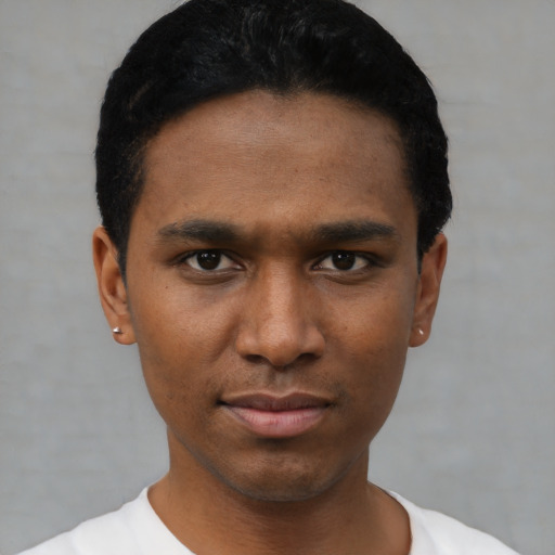 Joyful black young-adult male with short  black hair and brown eyes