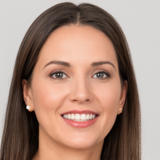 Joyful white young-adult female with long  brown hair and brown eyes