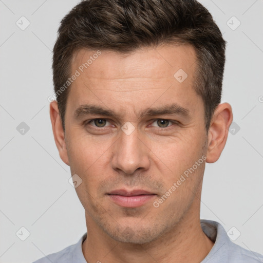 Joyful white adult male with short  brown hair and brown eyes