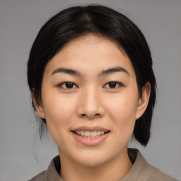 Joyful asian young-adult female with medium  black hair and brown eyes