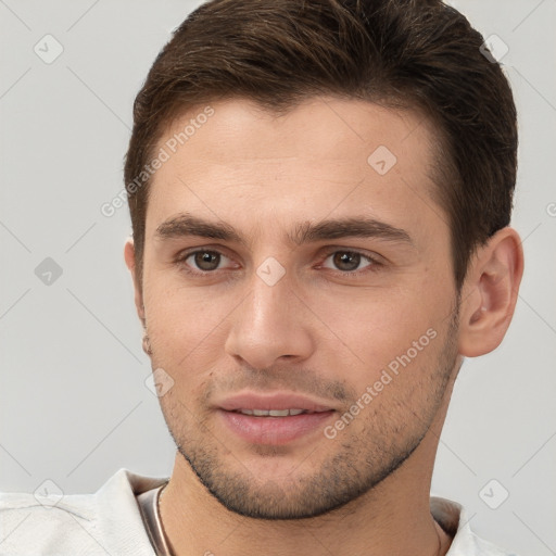 Joyful white young-adult male with short  brown hair and brown eyes