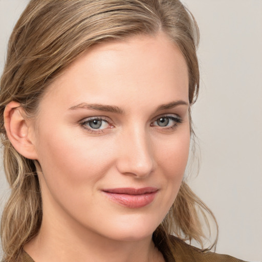 Joyful white young-adult female with long  brown hair and blue eyes