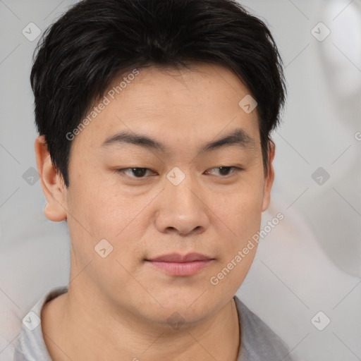 Joyful asian young-adult male with short  brown hair and brown eyes