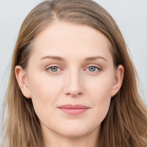 Joyful white young-adult female with long  brown hair and blue eyes