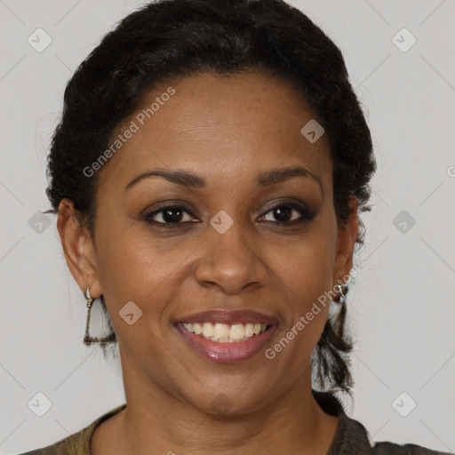 Joyful black adult female with short  brown hair and brown eyes