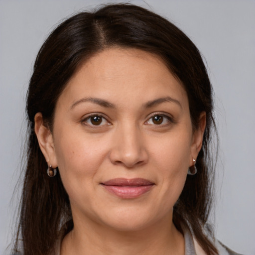 Joyful white adult female with medium  brown hair and brown eyes