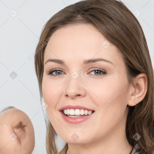 Joyful white young-adult female with medium  brown hair and grey eyes