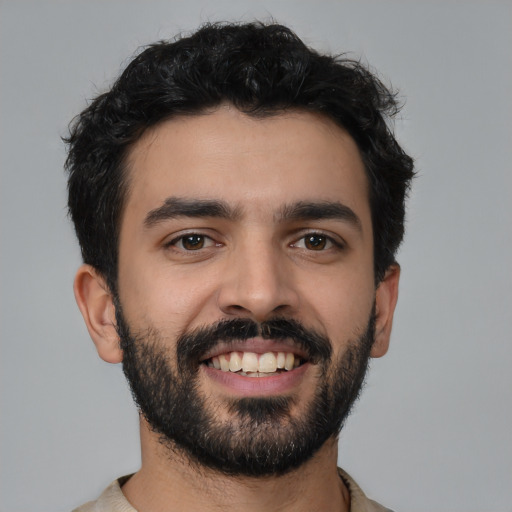 Joyful latino young-adult male with short  black hair and brown eyes