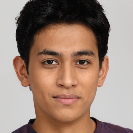 Joyful latino young-adult male with short  brown hair and brown eyes