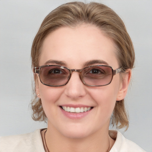 Joyful white young-adult female with medium  brown hair and blue eyes