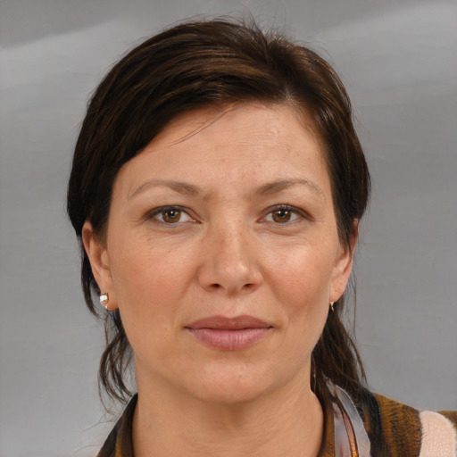 Joyful white adult female with medium  brown hair and brown eyes