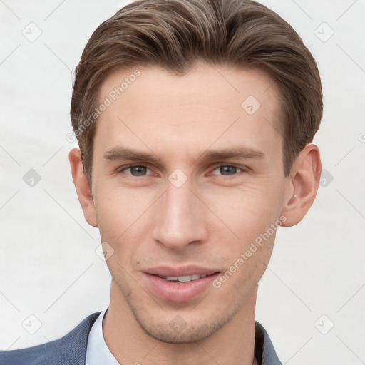 Joyful white young-adult male with short  brown hair and grey eyes