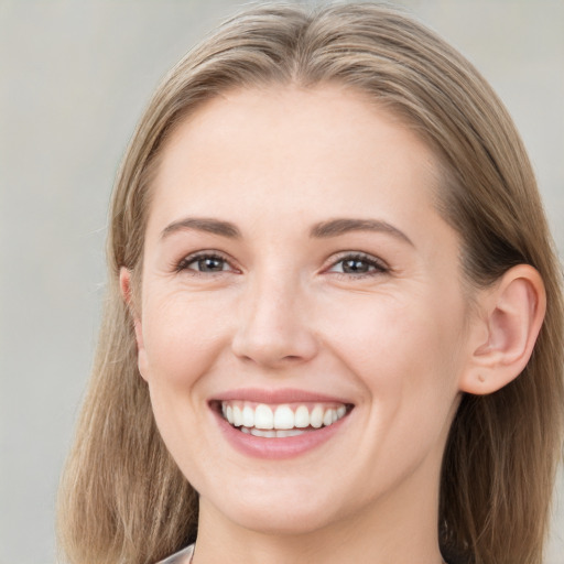 Joyful white young-adult female with long  brown hair and grey eyes