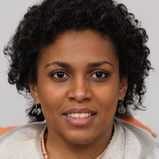 Joyful black young-adult female with short  brown hair and brown eyes