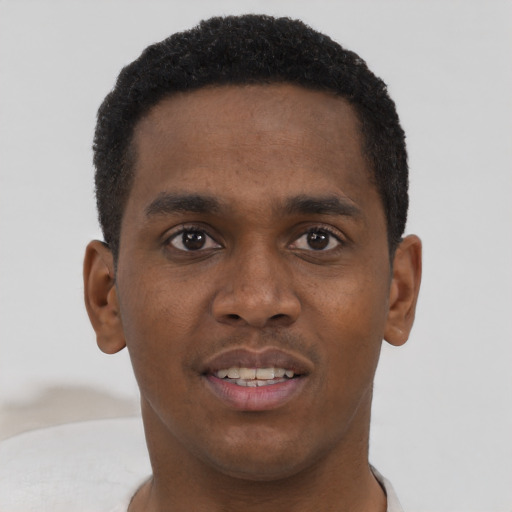 Joyful black young-adult male with short  brown hair and brown eyes