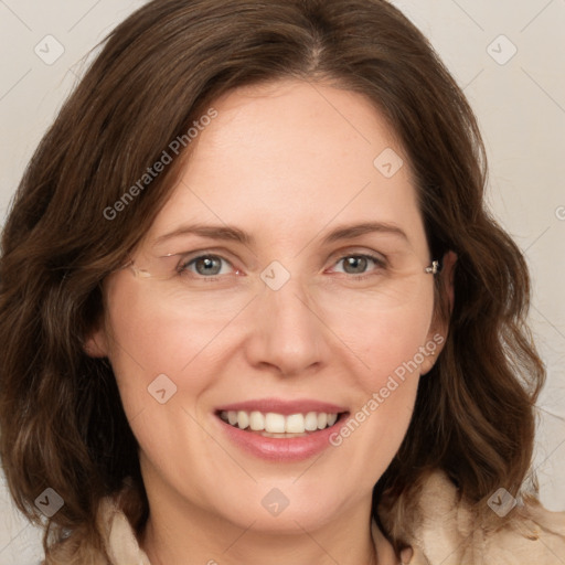 Joyful white adult female with medium  brown hair and grey eyes