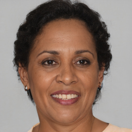 Joyful black adult female with short  brown hair and brown eyes