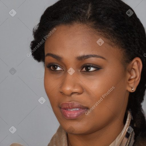 Joyful black young-adult female with long  brown hair and brown eyes