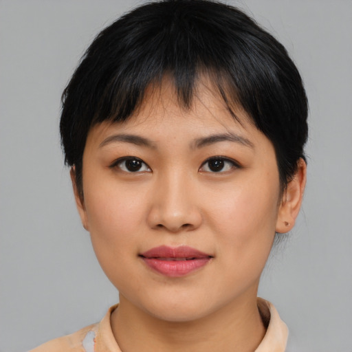 Joyful asian young-adult female with short  black hair and brown eyes
