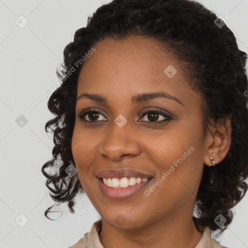 Joyful black young-adult female with medium  black hair and brown eyes