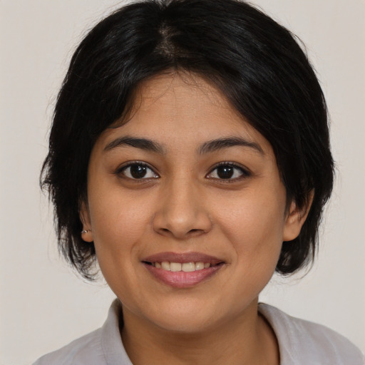 Joyful asian young-adult female with medium  black hair and brown eyes