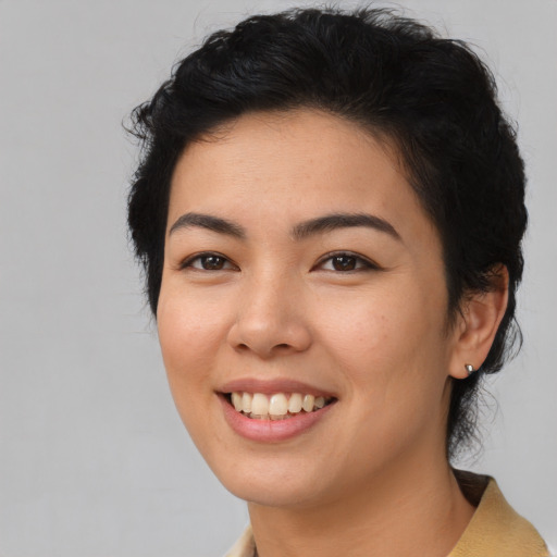 Joyful asian young-adult female with medium  black hair and brown eyes