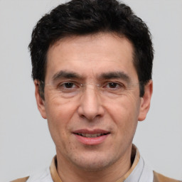 Joyful white adult male with short  black hair and brown eyes