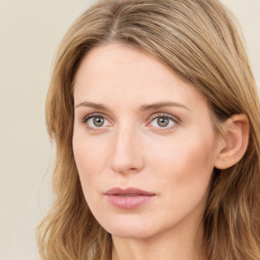 Joyful white young-adult female with long  brown hair and green eyes