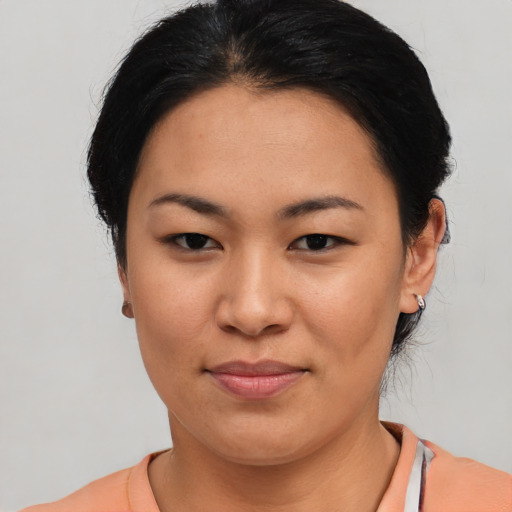 Joyful asian young-adult female with short  black hair and brown eyes