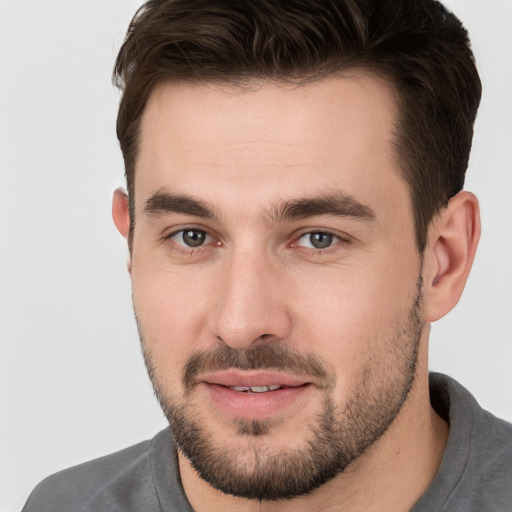 Joyful white young-adult male with short  brown hair and brown eyes