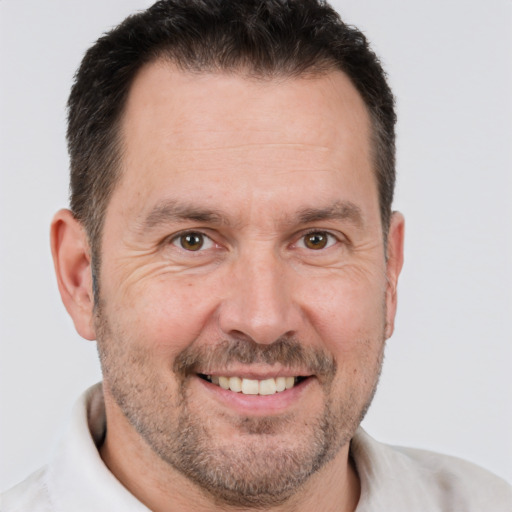 Joyful white adult male with short  brown hair and brown eyes