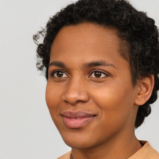Joyful black young-adult male with short  brown hair and brown eyes