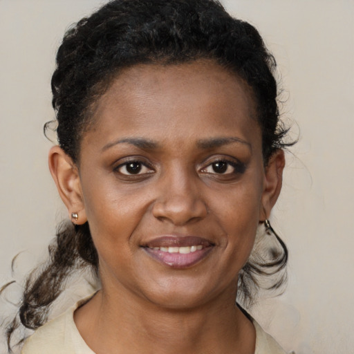 Joyful black young-adult female with medium  brown hair and brown eyes