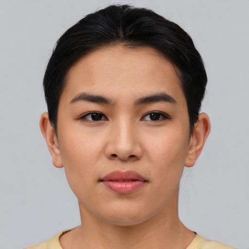 Joyful latino young-adult female with short  black hair and brown eyes