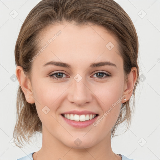 Joyful white young-adult female with medium  brown hair and grey eyes