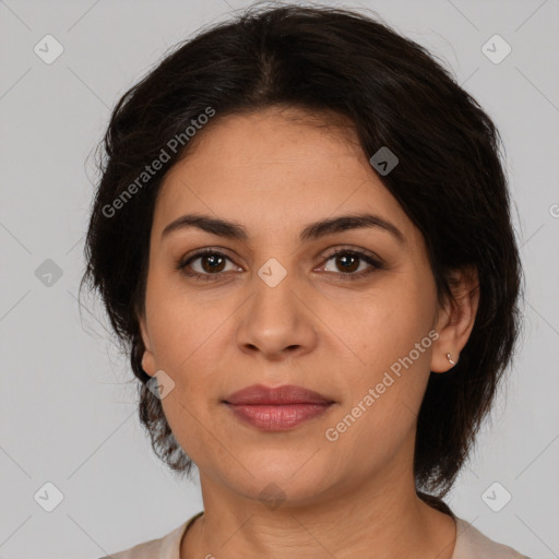 Joyful latino adult female with medium  brown hair and brown eyes