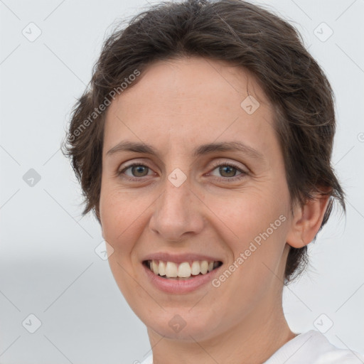 Joyful white adult female with short  brown hair and brown eyes