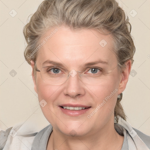 Joyful white adult female with medium  brown hair and blue eyes